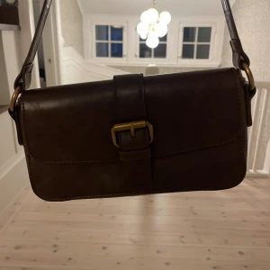 Brandy Melville väska - Fin väska från brandy Melville💕 säljer då det inte är min stil längre Väskan har knappt några tecken på användning Sista bilden ser man bäst färgen❤️