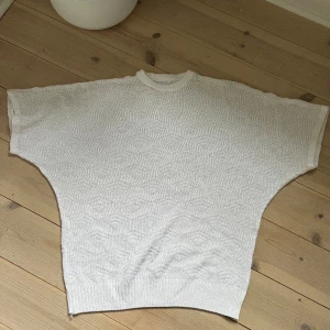 Vit stickad t-shirt  - Super fin stickad kort armad med en gullig mönster. Vet inte vart den är ifrån eller storleken men sitter nog som xs/s. Fint skick förutom en lite hål på axeln som visas på bild 3 som går knappt att märka. 