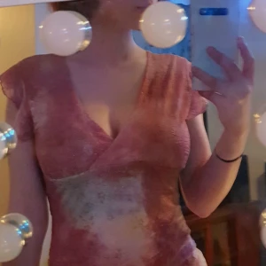 Rosa småglittrig topp - Köpte denna i USA några år sedan men har aldrig kommit till användning. Har använt den endast en gång. Blusen har blomma-liknande ärmar som man ser på bilden. Har bra material som är tunn men inte genomskinlig. 