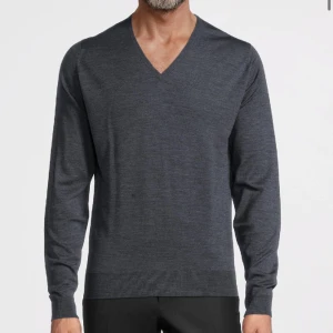 John Smedley Lundy merino pullover charcoal Xl - Klassisk pullover med rund hals från John Smedley stickad i extrafin merinoull. Bär med en skjorta, eller för mer avslappnade tillfällen, över en t-shirt i bomull. Crew neck Regular fit 100% Merinoull. Nypris: 2800kr. Bra skick. Storlek XL.