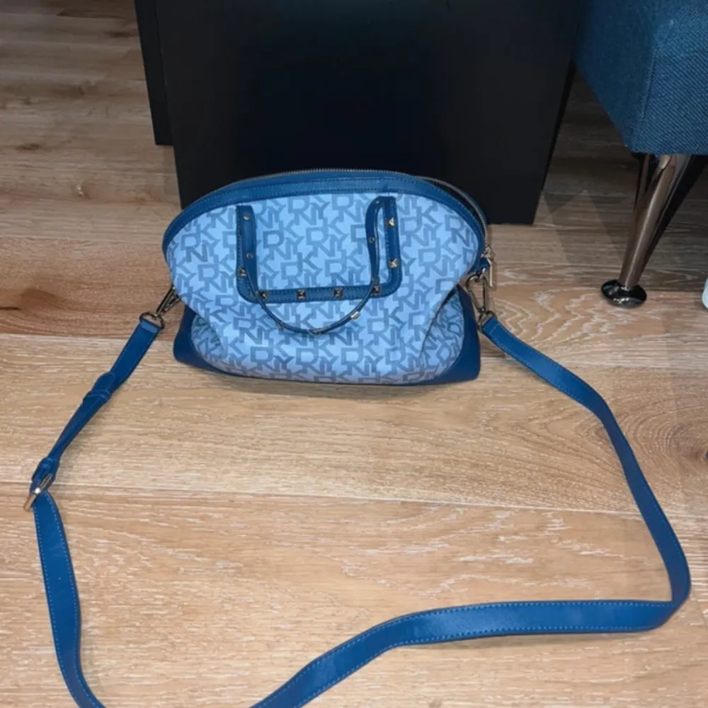 Blå DKNY väska kan har det som handväska eller crossbody ganska stora runt 31cm långa och 25cm hög. Väskor.