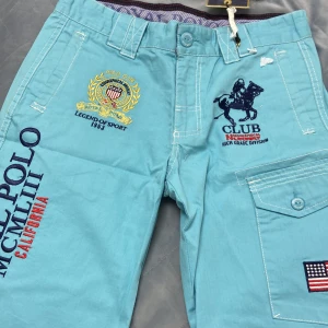 Royal Polo MCMLIII shorts ifrån geographical norway - Turkosa cargo shorts ifrån geographical norway. Royal polo mcmliii Storlek M