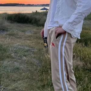 Axel Arigato Track pants - Säljer mina Axel Arigato byxor i Storlek L. Använda ett fåtal gånger och är i fint skick. Nypris 2000