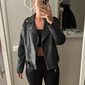 Svart skinnjacka  - Svart skinnjacka i något matt material (PU) i strl 36 (Har vanligtvis S/M). Från Missguided men köpt på Nelly.com Kan skicka mot fraktkostnad alternativt hämtas/mötas i Stockholm💕