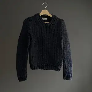 This sweater appears to be a rare piece made by Acne Studios before 2014.  White next to the tag is a thread that was cut, not seen when worn. Perfect condition
