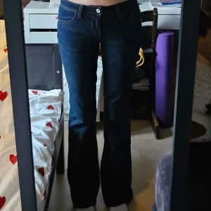 Mörkblå lågmidjade bootcut jeans - Lågmidjade bootcut jeans ifrån h&m. Har mönstrade fickor och är mörkblå och väldigt snygga på. Passar mig som är 170 lång, men passar även längre och kortare. Storlek 34 men passar även 36. Skriv vid frågor eller prisförslag.