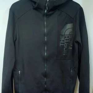 Svart The North Face ziphoodie - Svart ziphoodie i storlek Medium i fint skick