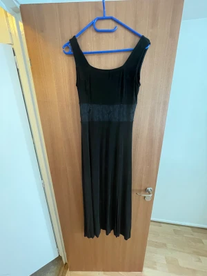 Black dress with lace midsection - Long black dress with sheer lace mid section. Good condition. 