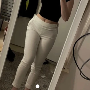 Vita low waist kostymbyxor  - Vita low Waits kostym byxor i storlek 36. Guldiga spännen på sidorna