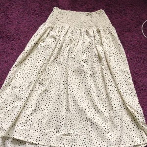Vit långkjol - Vit/beige långkjol med svarta prickar. Superskön med stretch i midjan ❤️säljer pga Kmr ite t användning ❤️liten storlek pga längden 🩵fint skick, pris diskuterbart. Tog långkjol på frakt, men den blir mindre när man viker ihop den 🩷🤷🏼‍♀️har två av denna 