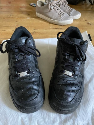 Air Force 1 - Jag säljer då min killes svarta air forces, skicket är 6/10 helt okej, inga skador inga hål, men användning syns, han köpte in dom för 1200, pris kan diskuteras 