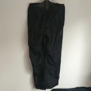 Regnbyxor Didriksons stl S - Svarta regnbyxor ifrån Didriksons i stl S. Stormsystem teknologi med tillhörande påse som syns på sista bilden. Köparen står för frakt. 