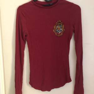 Red Gryffindor long sleeve shirt bought at warner bros studios, london