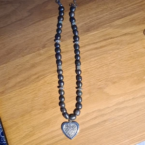 Halsband - Länk med grå "pärlor" och några silvriga inslag. Hänge med hjärta med strasspärlor, 2,5 cm. Reglerbar,  max 48 cm.