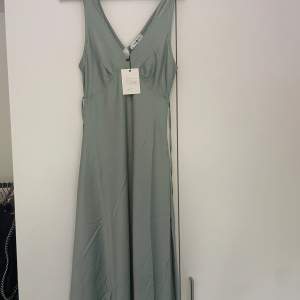 Jääätttefin grön satin klänning köpt i Australien. Har inte fått tillfälle att använde den så den är helt ny, prislappen sitter kvar! Storlek 38 ✨☺️❤️