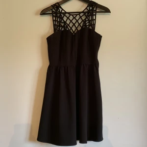 Svart klänning - Svart klänning från HM med v-ringad rygg och u-ringad fram. Använd fåtal gånger. Storlek 35, men något kort i storlek. 