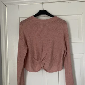 tröja  - rosa tröja med knut på magen, ganska kort vid magen alltså mer av en magtröja och inte så använd 