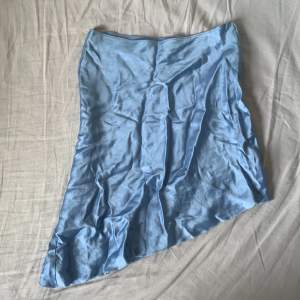 Jätte gullig asymmetrisk ljusblå kjol! Har en pytteliten brun fläck som nog går bort i tvätten men annars i väldigt gott skick!!🩵🩵