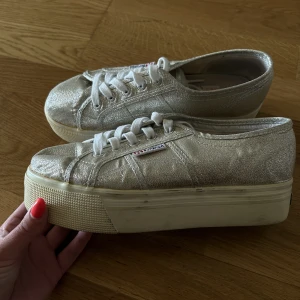 Superga platåskor  - Supersnygga platå skor från Superga i silver. Storlek 38. Använda men går absolut att putsa till om så önskas. 