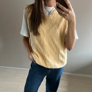 Gul väst - Gul väst med rutigt mönster som är köpt second hand. I jättefint skick från märket Izod. 