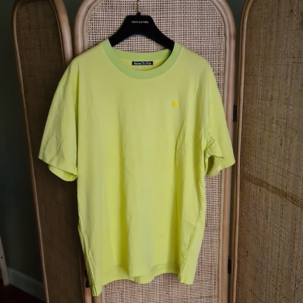 Acne Studios tshirt in yellow with green neck rib and seams, and face patch. From SS21. Bought at sample sale, never worn/washed. New sample condition. Pen mark in label in neck was made before purchase . T-shirts.