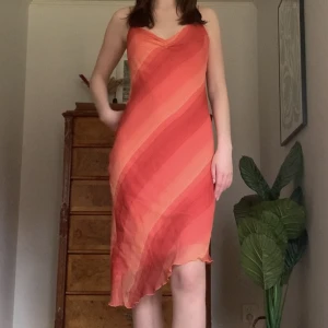 Randig klänning - Rosa/röd midiklänning i randigt mönster och med justerbara band, från märket Esprit! Är snedskuren nertill ❤️‍🔥