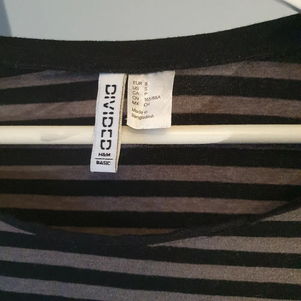 Randig tröja i svart och grått från H&M. Tight passform och långa ärmar. Lite nopprig på vissa ställen. . Tröjor & Koftor.