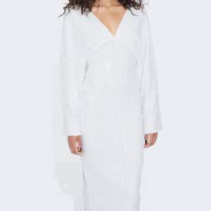 En vit plaljettklänning från bikbok. Helt oanvänd med prislappen kvar. Storlek S. Köpt för 799 kronor. Superfin klänning!!❄️