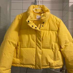 Gul pufferjacket - Hannalicious x NA-KD - Gul varm pufferjacket i storlek 40 från Hannalicious kollektion med NA-KD säljes. Den är i en lite kortare modell, se sista bilden. Endast använd några fåtal gånger så den är i fint skick! ✨   Finns att hämta i Högdalen!
