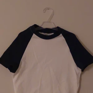Magtröja - En vit och mörkblå magtröja. Aldrig använd. Säljs pga för stor.