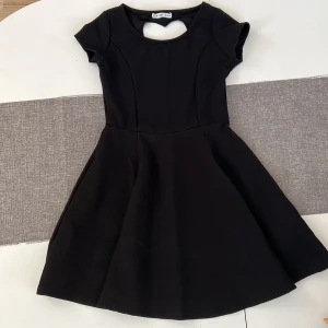 Svart klänning  - Svart klänning med öppning på ryggen. Väldigt bekvämt och skönt material.