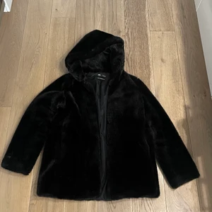 Fuskpäls kappa  - Jättefin kappa av fuskpäls med luva från zara. Går enkelt att stänga (se bild). I toppenskick och är i storlek s.  
