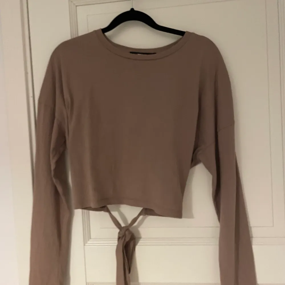 En väldigt fin tröja aldrig använd från bil bok hyfsat tajt och med öppen rygg som man kan knyta rosett i lite kaffe beige. Köpt för 250 säljs för 160. Blusar.