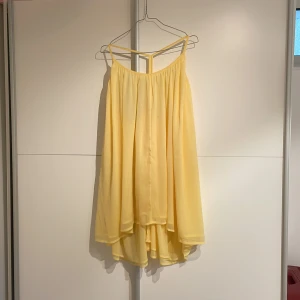 Gul klänning NAKD  - Söt klänning från NA-KD med öppen rygg.