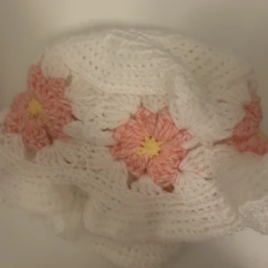 Blommig virkad mössa - En handgjord virkad mössa med rosa blommor. Som en buckethat. Passar alla och allt🥰