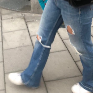 Flare Jeans med slitningar  - Jeans med hål och slitningar. Urtvättad blå färg. 