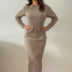 Långklänning - Säljer denna fantastiska långklänning från Arket. Klänningen är inte skrynklig utan det är texturen. På mig som är ca 162 går den nästan ner till anklarna. Köparen står för frakten annars kan jag mötas upp. Betalning sker via swish.