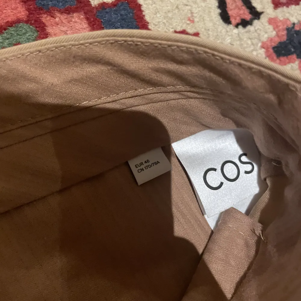 Vida beiga kostymbyxor från COS. Använda ett fåtal gånger. Stlk 48 sitter som 32/32, nypris 950. Jeans & Byxor.