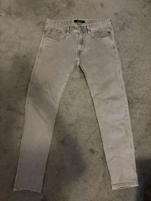 Replay jeans  - Snygga gråa skinny jeans från replay med klassisk femficksdesign och normalhög midja. Jeansen har smal passform och är tillverkade i ett mjukt bomullsmaterial med lite stretch för extra komfort. Perfekta för en trendig och avslappnad look.