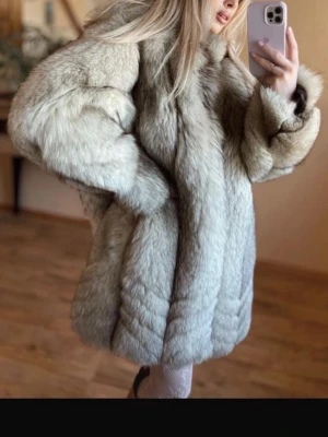 Blåräv beige pälsjacka - Säljer en blåräv  beige pälsjacka med bred krage och långa ärmar. Jackan har en fluffig och lyxig look med mjukt material som ger en exklusiv känsla. Perfekt för dig som vill sticka ut och hålla dig varm under kalla dagar.
