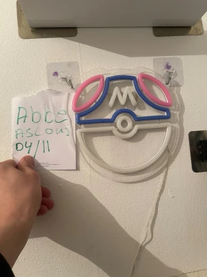 Pokémon neonlampor Pokéboll & Masterball - Två coola neonlampor i form av en Pokéboll och en Masterball från Pokémon. Lamporna är gjorda av plast och neonrör i färgerna röd, vit, blå och rosa. Perfekt som dekoration till gamingrummet eller samlarhörnan. Drivs med sladd och kan hängas på väggen. Båda lamporna för 1500 eller 800  per styck 