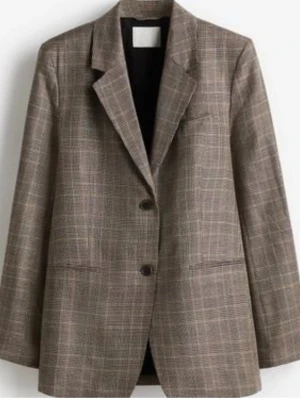 Brun rutig oversized kavaj - Snygg beige/brun rutig kavaj och knappar framtill. Oversized passform med klassisk krage och två fickor