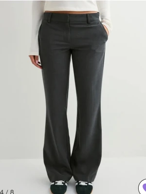 Grå Low waist kostymbyxor Nelly - Skit snygga mörkgrå kostymbyxor från Nelly med låg midja och utsvängda ben 💘 Helt nya med prislapp. Nypris 399kr. Pris kan diskuteras, skicka prisförslag.