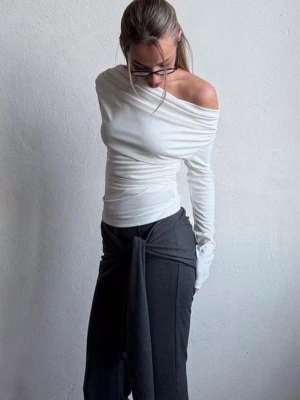 Vit off shoulder topp med rynk - Med prislappen på! Slut i butiken. Trendig vit långärmad topp med off shoulder-design och snygga rynkdetaljer över bröstet. Tunn och stretchig kvalitet som sitter tight och markerar axlarna. Perfekt för dig som gillar en stilren men ändå unik look.