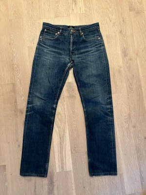 A.P.C. Japanese Selvedge - ljusblå - size 28 - Säljer ett par A.P.C. Petit Standard i klassisk ljusblå denim. En ikonisk modell från A.P.C. med straight fit, något mer utrymme i låren och avsmalnande ben, så nästintill slim/straight! Storlek 28, skick 9/10.   Tillverkade i japansk selvedge denim av hög kvalitet som formar sig efter kroppen och får snygga naturliga fades över tid. Dessa har redan utvecklat fin patina som ger dem karaktär. Vid fler frågor får du gärna skriva och vid snabb affär går pris att diskuteras!