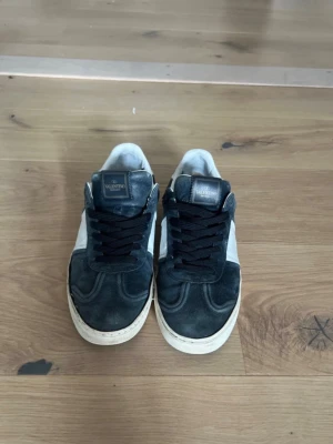 Valentino sneakers i svart och vitt - Säljer ett par feta valentino skor som är bra skick förutom att ena skons sula har gått av lite men det går att fixa hos en skomakare som syr eller så kan man limma eller sy själv.Skorna är även Perfeckt för sommar och öven vår.