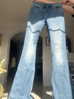Lågmidjade bootcut jeans - Snygga ljusblå bootcut jeans med klassisk femficksdesign och gylf med dragkedja. Jeansen har en lätt tvättad look och är tillverkade i denim med en skön passform. Perfekta för dig som gillar retrostil och vill ha ett par jeans med lite utsvängda ben💕Säljer för de är för små🤍Kolla in min profil för fler fina och trendiga plagg!