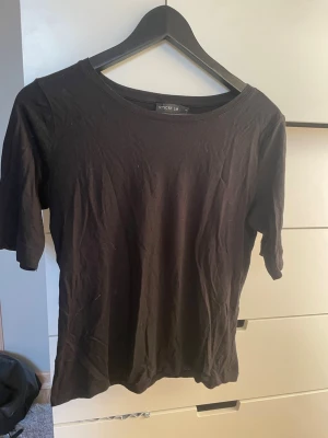 Svart t-shirt från STOCKH LM - Svart t-shirt med lite längre armar från STOCKH LM. Mjukt material som funkar under en annan tröja eller bara som den är. 