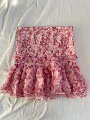 Rosa volangkjol med blommönster - Fin rosa volang kjol. Bra skick och från ginatricot🥰