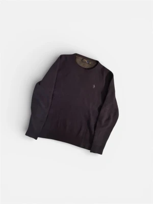 Mörkblå stickad tröja i 100% Kashmir Polo Ralph Lauren - Snygg mörkblå stickad tröja från Polo Ralph Lauren med rund halsringning och diskret broderad logga på bröstet. Tröjan har långa ärmar och är tillverkad i mjukt material som passar perfekt till lager på lager-stil. Storlek M men passar mer s. Den är u 100% Kashmir 